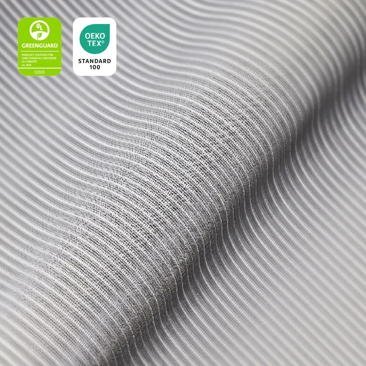Close-up of the ATLAS mesh with two printed seals: UL GREENGUARD Gold, product certified for low chemical emissions UL 2818, and OEKO-TEX Standard 100