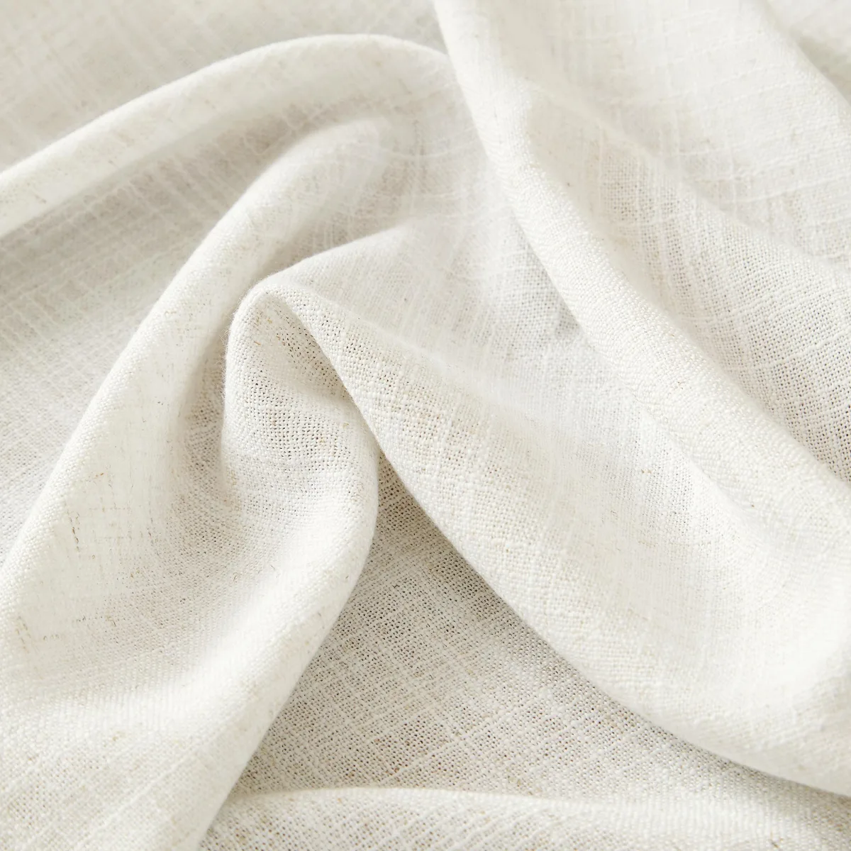 Close-up of the Lesley fabric folded on itself, showing the slubbed linen-look weave in off-white