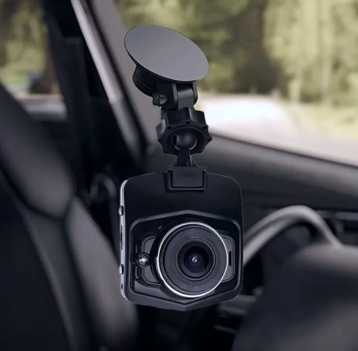 The DashOne Pro dash cam on its suction mount, seen from the front with the lens and the screen housing