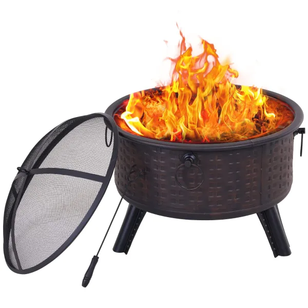 The 26-inch wood-burning fire pit in black steel with a basket-weave pattern, flames rising from the bowl, the mesh spark screen and the poker beside it