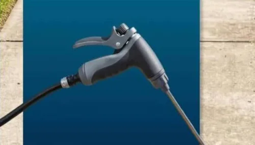 Close-up of the Jetterix body: trigger, threaded collar and a garden hose already screwed onto the inlet