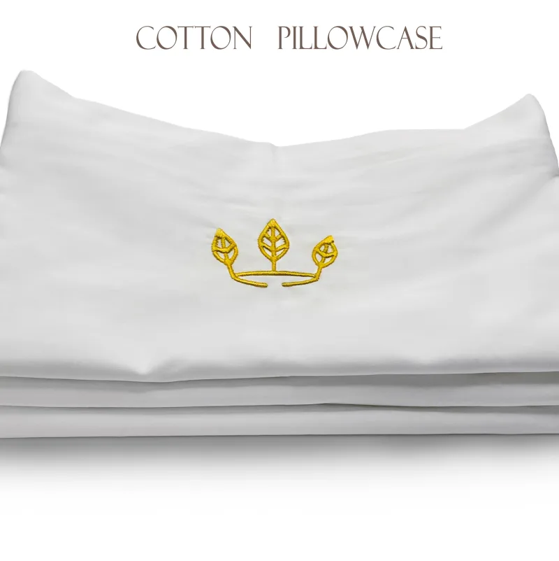 A stack of folded white cotton pillowcases, a gold three-leaf crown embroidered on the top one, lettered Cotton Pillowcase above