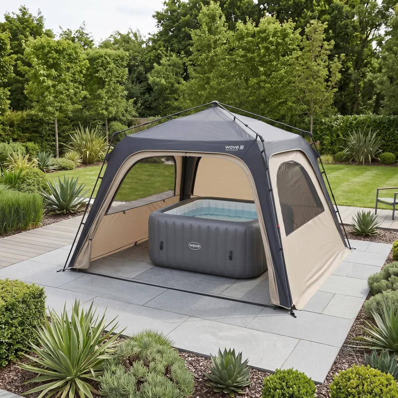 The Wave Quick-Pitch Spa Shelter, a square gazebo tent, pitched over a grey square inflatable hot tub on a paved garden