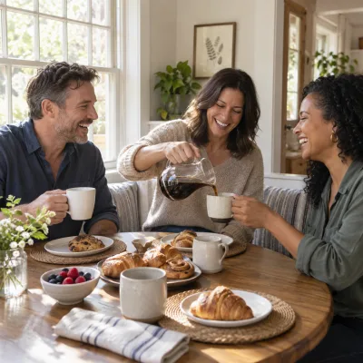 Three friends in their forties pouring coffee from a glass carafe around a breakfast table